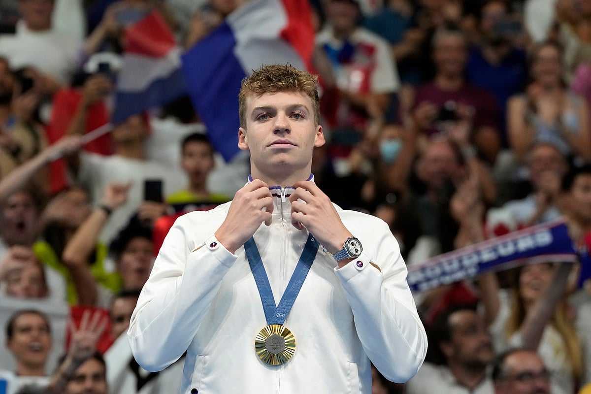 Leon Marchand of France, reacts after receiving his gold medal for the men's 200-meter individual medley final at the 2024 Summer Olympics, Friday, Aug. 2, 2024, in Nanterre, France. 

 - (AP Photo/Natacha Pisarenko)
